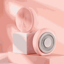 Load image into Gallery viewer, Pink Zobelle Facial Cleansing Brush with EMS and LED light therapy on pastel pink geometric blocks

